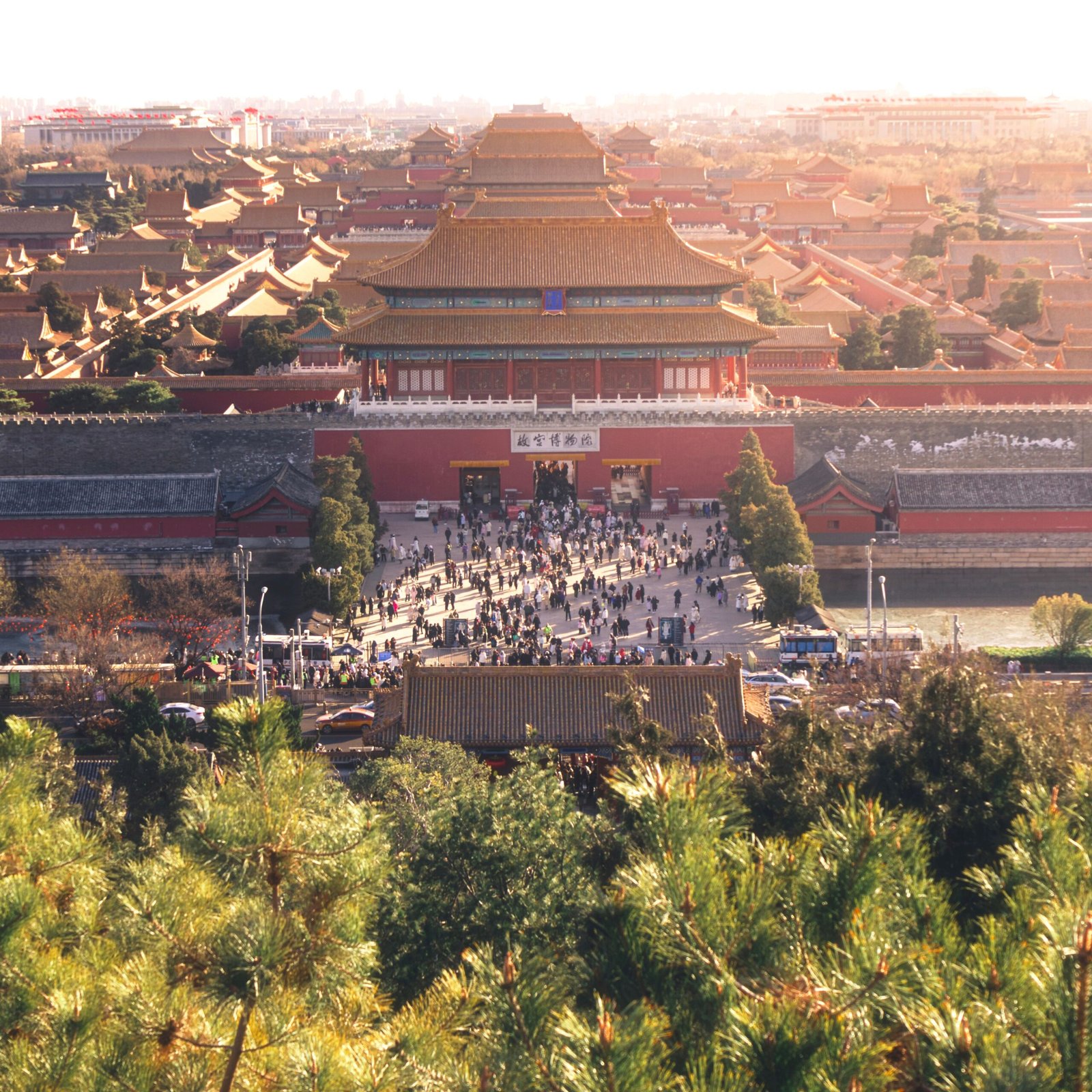 Explore the iconic Forbidden City in Beijing, showcasing traditional Chinese architecture and bustling crowds.