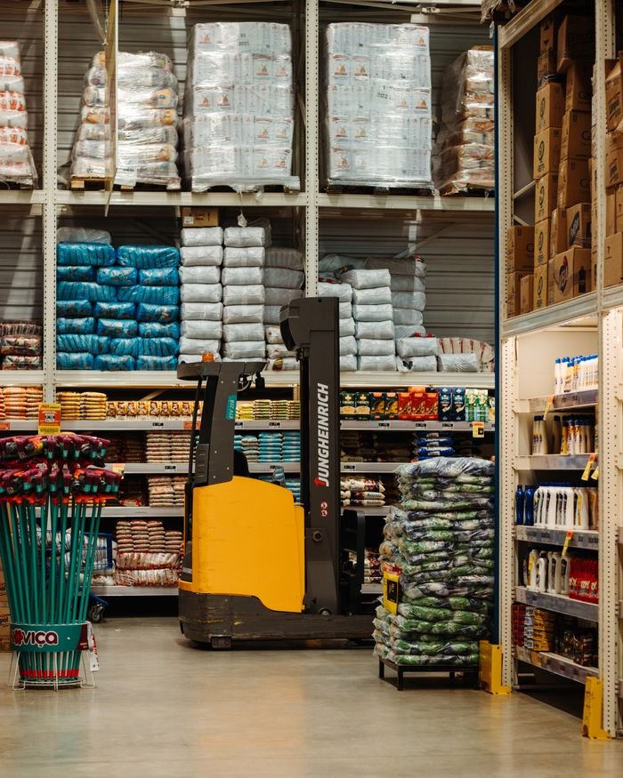 lawn-01 A warehouse with stacked goods, shelves, and a forklift in Brazil.