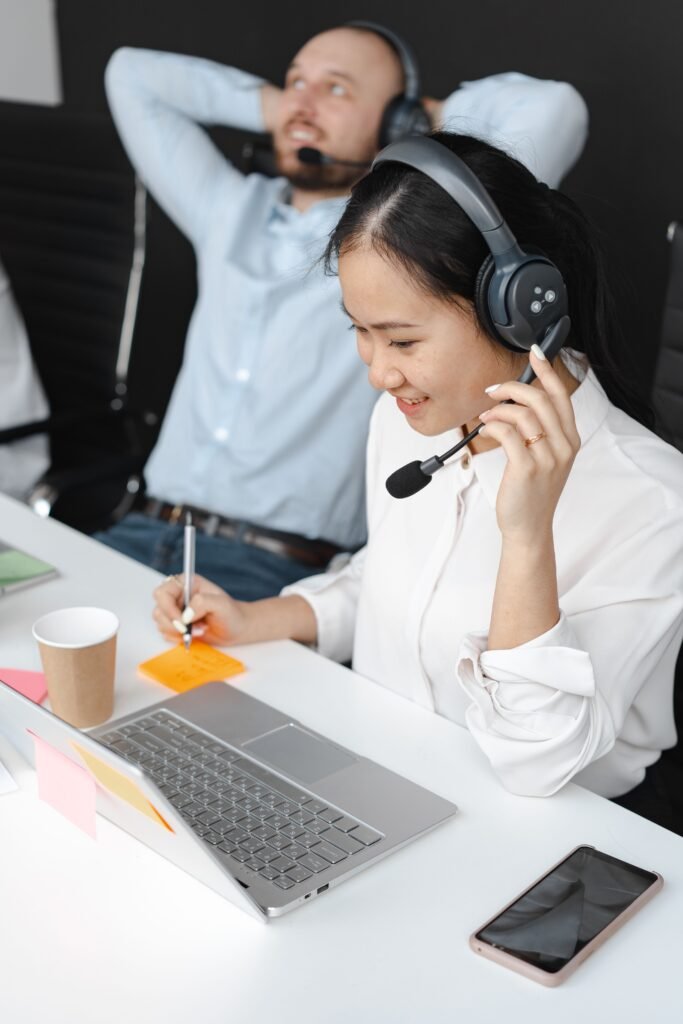 Two call center agents working in a modern office, enjoying their tasks and customer interaction.